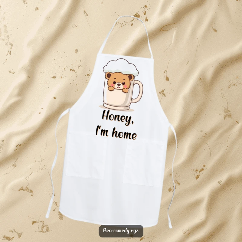 A playful bear cub peeks from behind a giant, foamy mug on a functional and charming kitchen apron.
