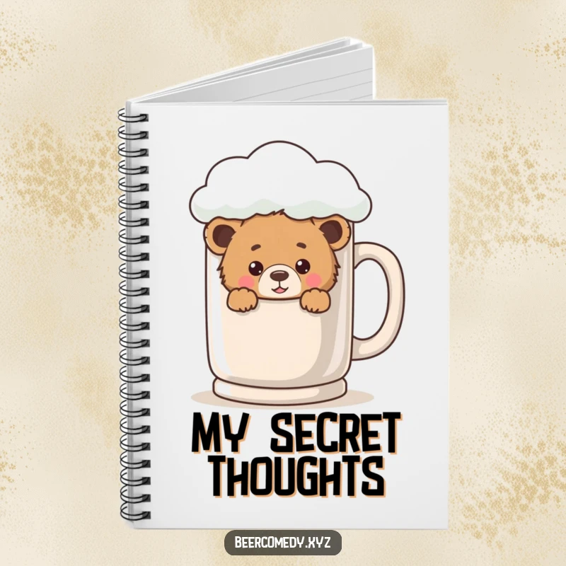 A playful bear cub is peeking from behind a giant, foamy mug on the cover of a notebook.